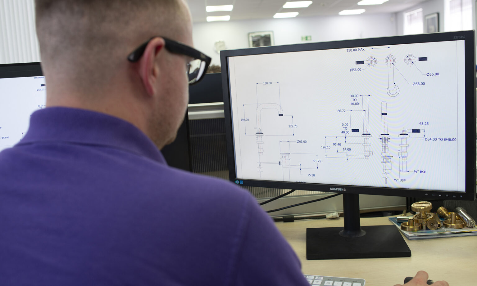 A design engineer producing 2D Computer Aided Design (CAD) drawings to optimise fitting instructions.